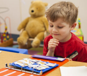 Young boy looking at a communication book