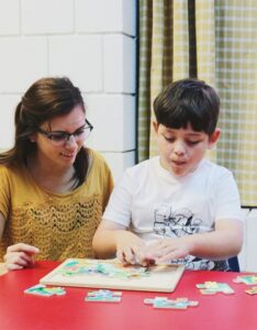 Teacher sitting with a student