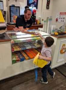 Child using PECS to buy candy at the movies