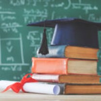 graduation hat atop school books