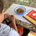 Boy with PECS IV+ app