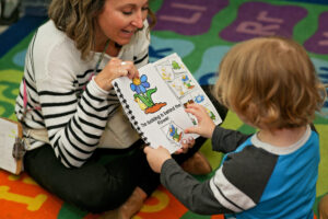 Student reading with teacher