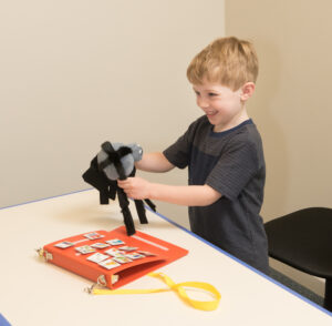 boy playing with spider puppet