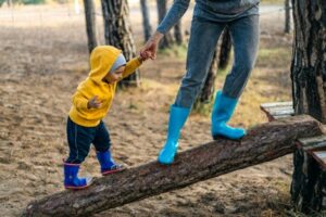 adult holding small child's hand