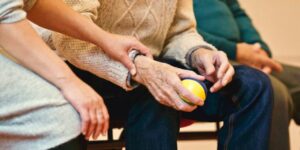 younger person holding arm of older person