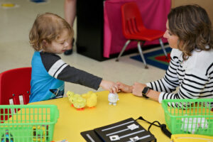 Student playing with toy duck reinforcer.