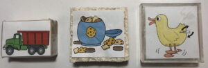 Pictured are images glued to various types of objects like blocks and sponges.