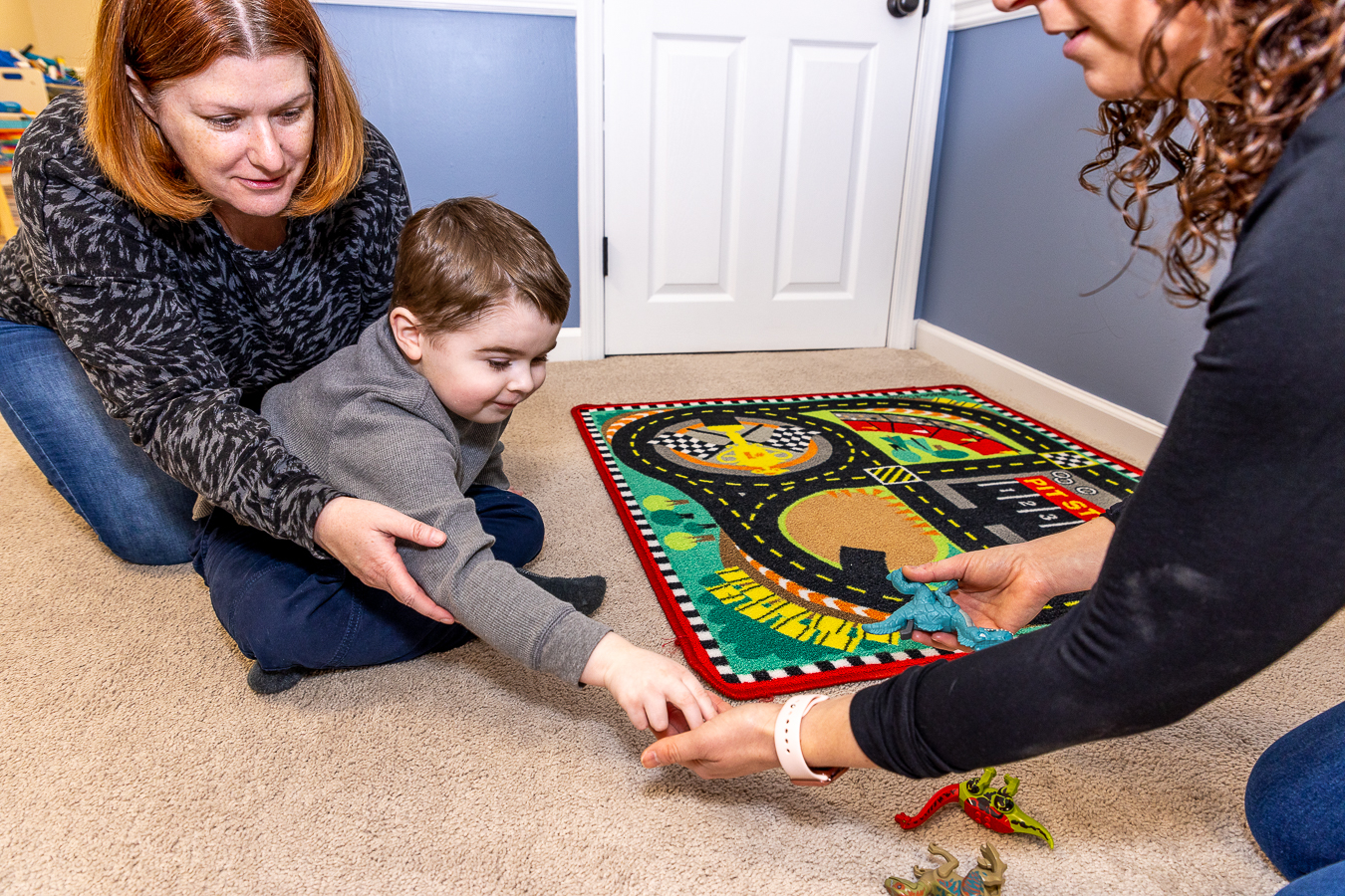 boy exchanging a picture for a dinosaur toy