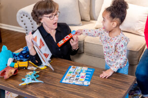 Child pointing to sentence strip