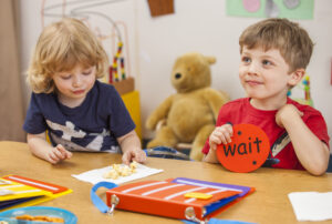 child holding a wait card