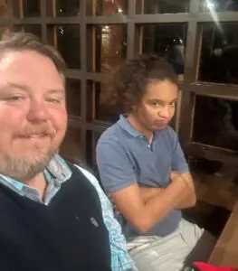 A father and son are sitting together in a restaurant