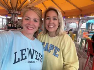 Two women are standing together smiling